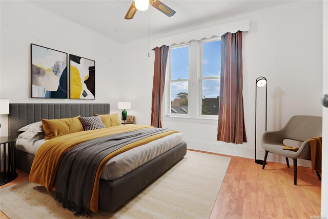 bedroom with light hardwood / wood-style flooring and ceiling fan