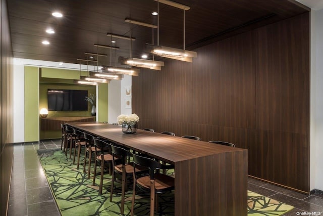 dining area featuring wood walls