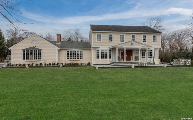 rear view of property with a yard