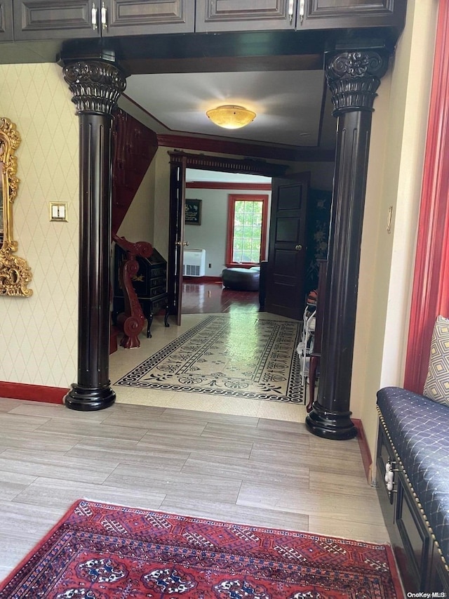 corridor with hardwood / wood-style floors and decorative columns