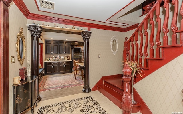 staircase featuring hardwood / wood-style floors and ornamental molding