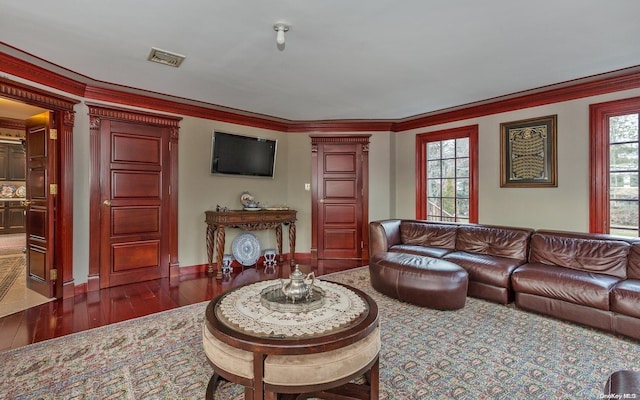 living room featuring dark hardwood / wood-style floors and ornamental molding