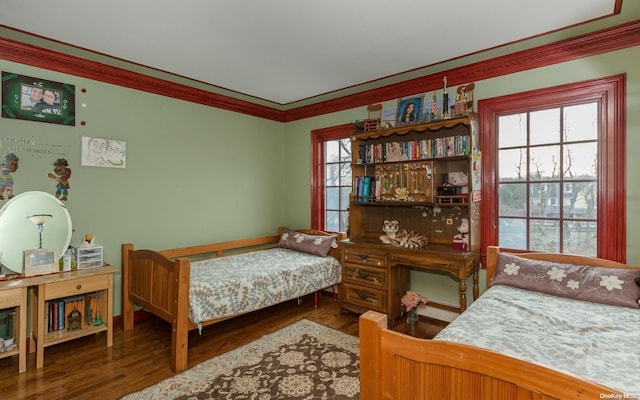 bedroom with hardwood / wood-style flooring and ornamental molding