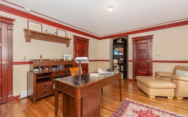 office featuring hardwood / wood-style floors, ornamental molding, and baseboard heating