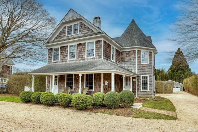 view of front facade featuring covered porch and an outdoor structure