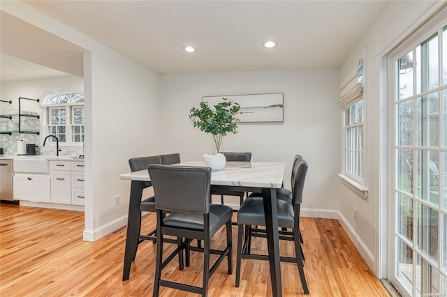 dining room with light hardwood / wood-style floors and sink