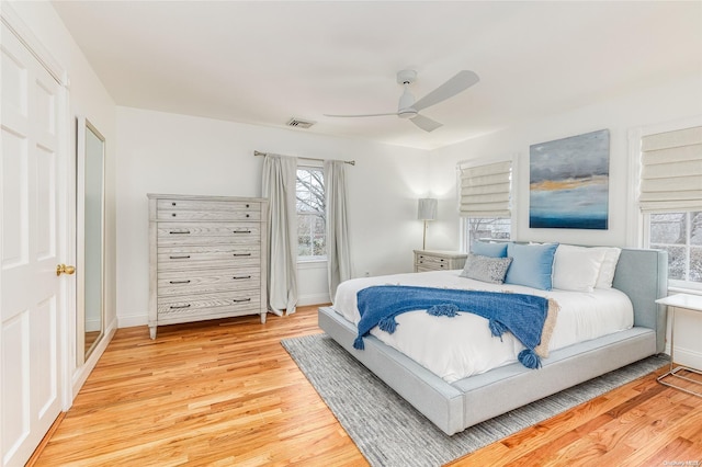 bedroom with ceiling fan and light hardwood / wood-style flooring