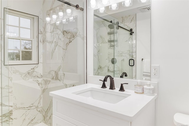 bathroom featuring vanity and a shower with door