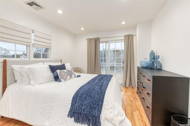 bedroom featuring light wood-type flooring and access to outside