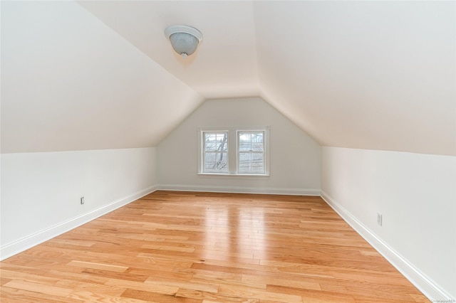 bonus room featuring light hardwood / wood-style flooring and vaulted ceiling