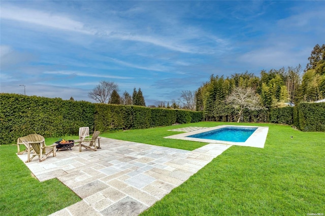 view of pool featuring a fire pit, a patio, and a lawn