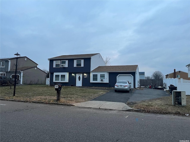 view of front of house featuring a garage and a front lawn