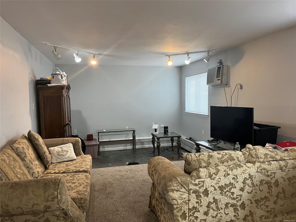 living area featuring an AC wall unit, dark colored carpet, and track lighting