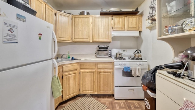 kitchen with light brown cabinets, light parquet floors, white appliances, and sink