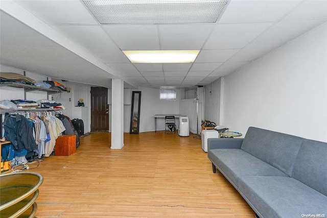 interior space featuring a paneled ceiling and light hardwood / wood-style flooring