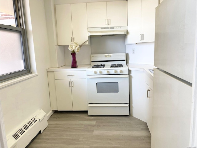 kitchen featuring white appliances, white cabinetry, light hardwood / wood-style flooring, and a baseboard heating unit