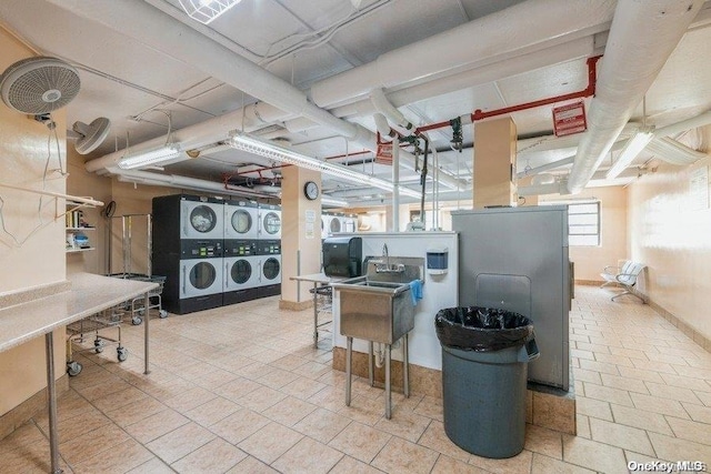 basement with stacked washer / drying machine and washing machine and clothes dryer