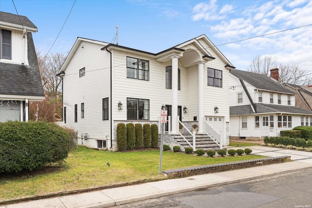 view of front of house featuring a front yard and a garage