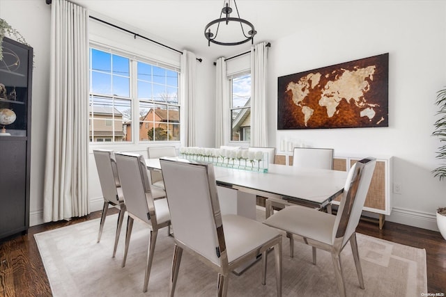 dining area with dark hardwood / wood-style flooring