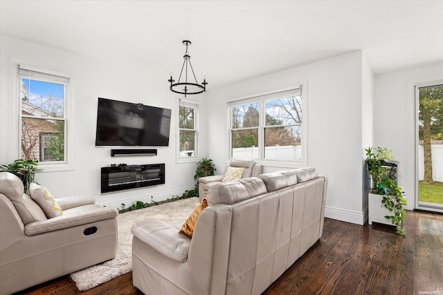 living room featuring dark hardwood / wood-style floors and a notable chandelier