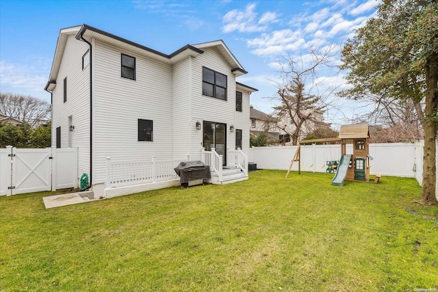 back of property featuring a playground and a lawn