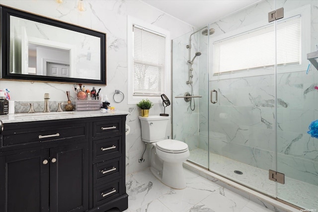 bathroom featuring vanity, toilet, and a shower with shower door