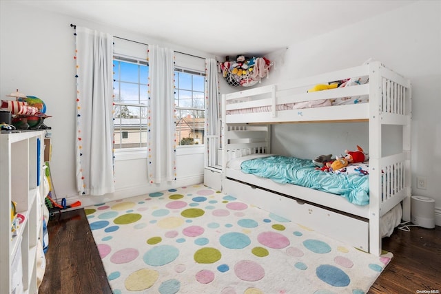 bedroom with dark hardwood / wood-style floors