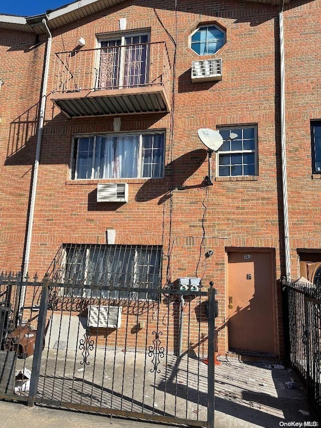 rear view of property with a balcony