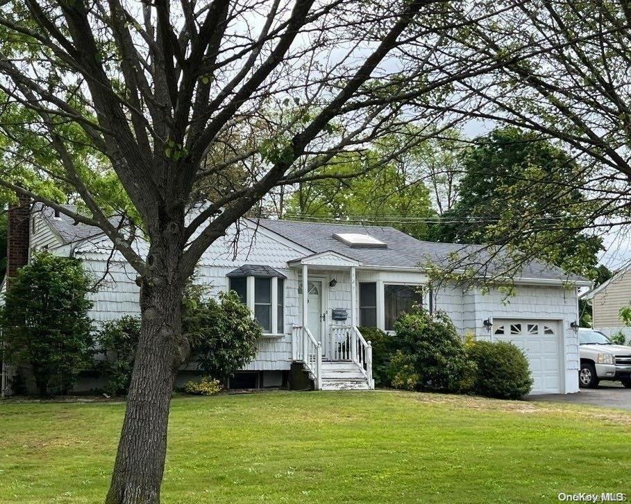 ranch-style home with a front yard and a garage