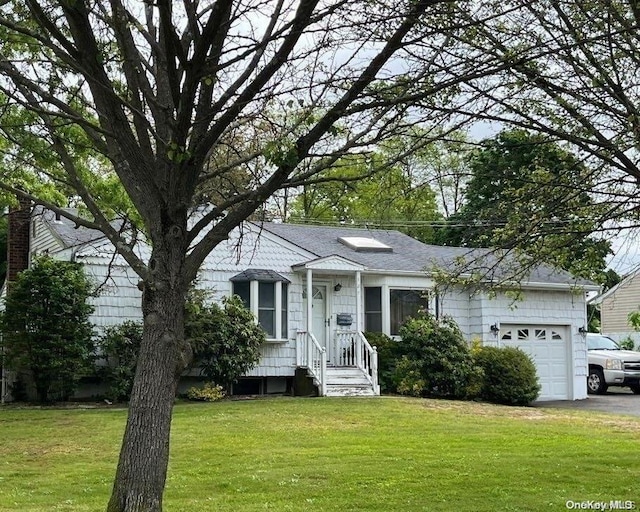 ranch-style home with a front yard and a garage