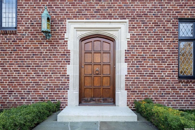 16 Tuthill Ln, Remsenburg, NY 11960 - doorway to property with brick siding