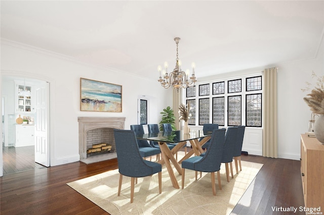 dining space with ornamental molding, dark wood-type flooring, and a notable chandelier