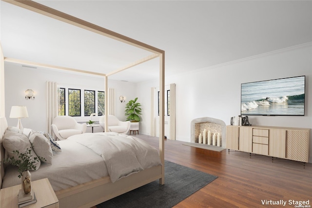 bedroom featuring ornamental molding and dark wood-type flooring