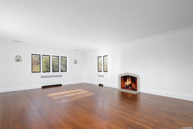 16 Tuthill Ln, Remsenburg, NY 11960 - unfurnished living room featuring a fireplace with flush hearth, dark wood-style floors, ornamental molding, and radiator heating unit