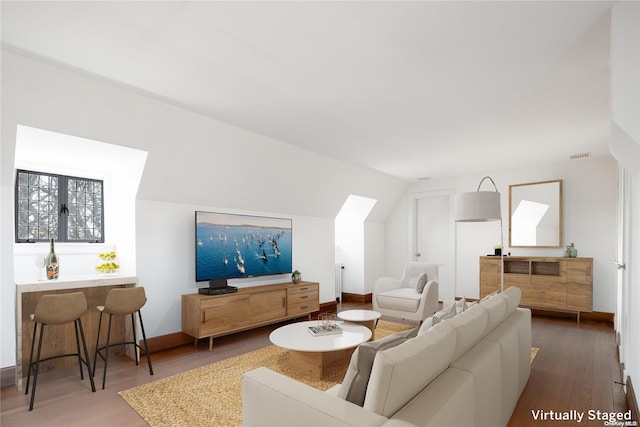 living room featuring wood-type flooring and lofted ceiling