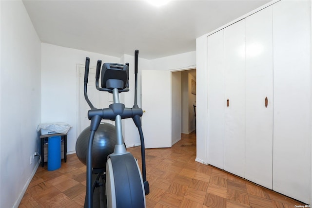 workout room featuring light parquet flooring