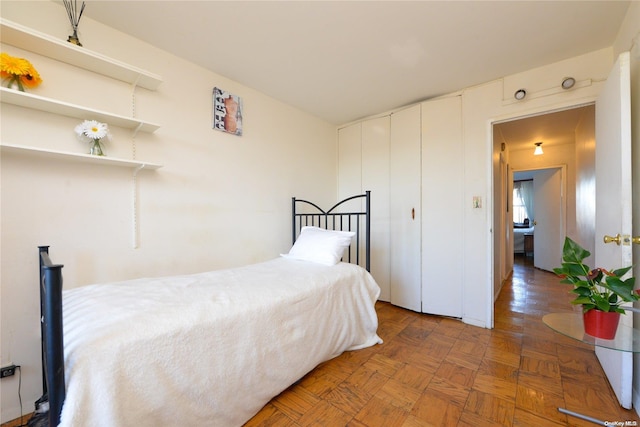 bedroom with dark parquet floors