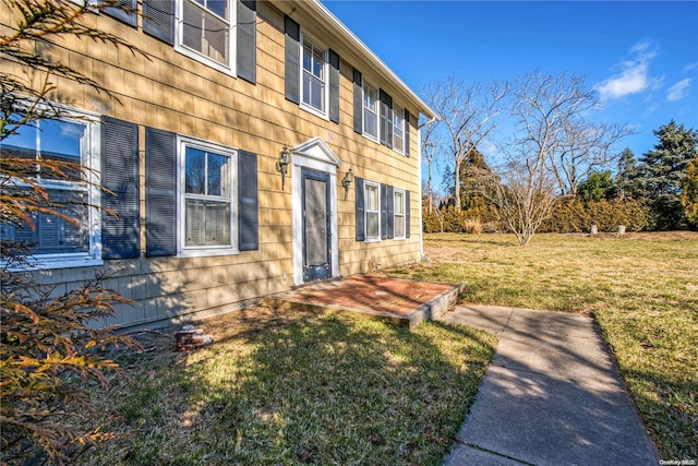 view of property exterior with a lawn