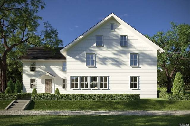 rear view of property featuring a yard