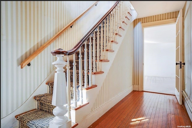 stairway with hardwood / wood-style flooring