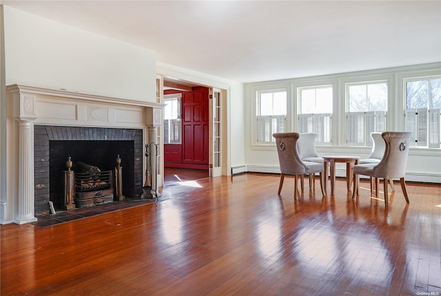 interior space with hardwood / wood-style floors and a brick fireplace