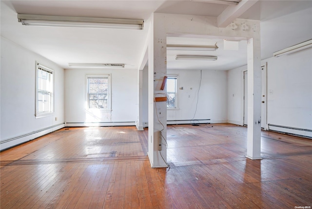 entrance foyer with wood-type flooring and a baseboard heating unit