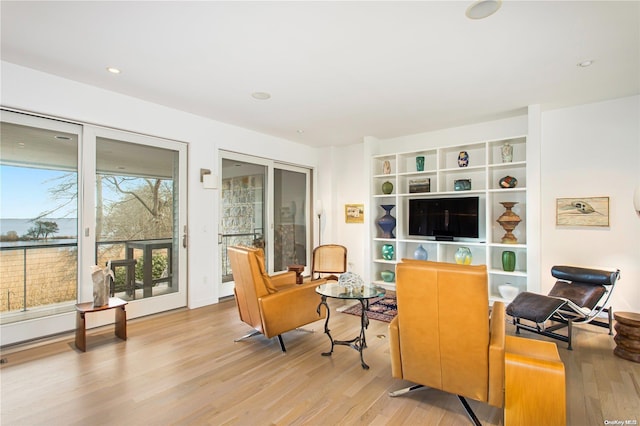 living area with light hardwood / wood-style flooring