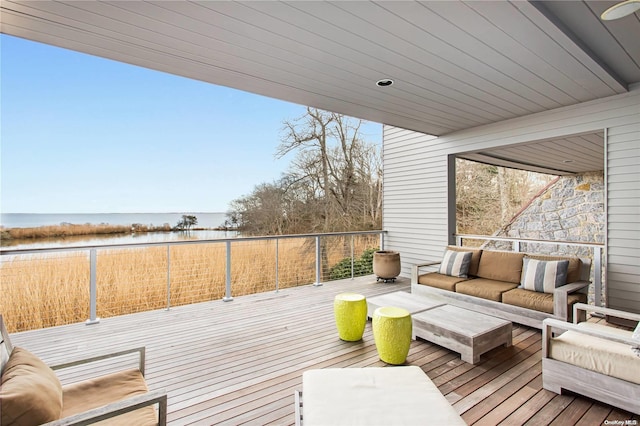 wooden deck with outdoor lounge area and a water view