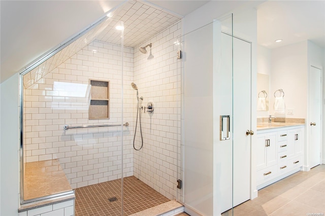 bathroom with tile patterned floors, vanity, and an enclosed shower