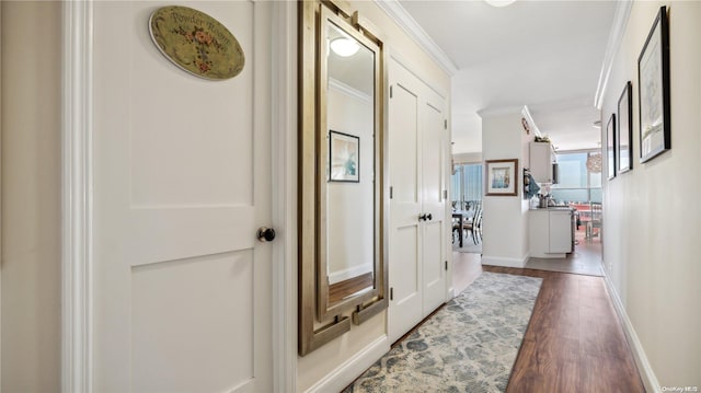 corridor featuring dark hardwood / wood-style flooring and ornamental molding