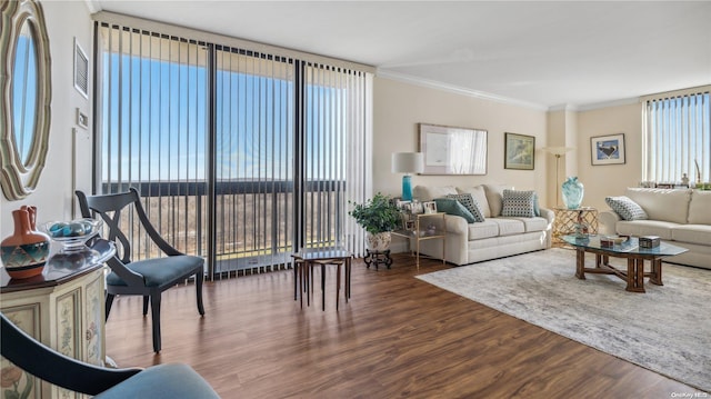 living room with hardwood / wood-style floors and ornamental molding