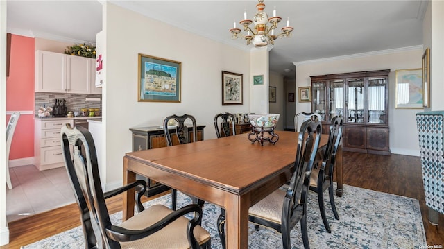 dining room with crown molding, hardwood / wood-style floors, and a chandelier