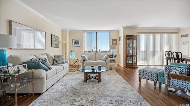 living room with dark hardwood / wood-style floors and crown molding