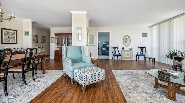 living room featuring crown molding, dark hardwood / wood-style flooring, and a chandelier